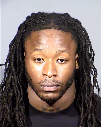 This Clark County, Nev., Detention Center booking photo shows New Orleans Saints running back Alvin Kamara following his arrest Sunday, Feb. 6, 2022, in Las Vegas on a felony battery charge. A judge in Las Vegas postponed until next month a hearing in an assault case involving two NFL players and two other men accused of severely beating a man at a Las Vegas Strip nightclub the weekend of the Pro Bowl. Kamara and Kansas City Chiefs cornerback Chris Lammons and two other defendants, Darrin Young 