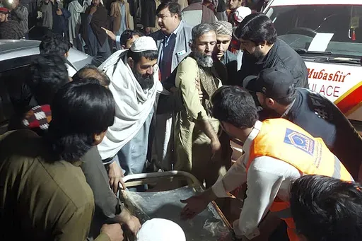 Rescue workers and volunteers help victims of a bomb explosion upon his arrival at a hospital, in Bannu, northwest Pakistan, Tuesday, March 4, 2025. (AP Photo/Ehsan Ullah Khan)