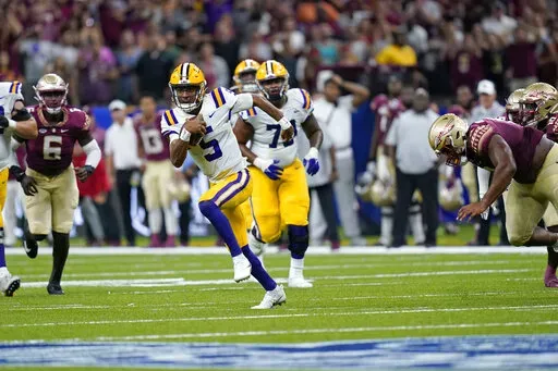 LSU quarterback Jayden Daniels (5) carries in the second half of an NCAA college football game against Florida State in New Orleans, Sunday, Sept. 4, 2022. Florida State won 24-23. (AP Photo/Gerald Herbert)