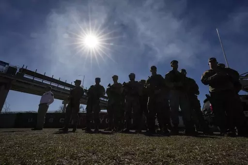 Members of the National Guard stand as Texas Gov. Greg Abbott and fellow governors hold a news conference along the Rio Grande to discuss Operation Lone Star and border concerns, Feb. 4, 2024, in Eagle Pass, Texas. Following the extraordinary collapse of a border security deal in Congress, Gov. Landry said on Thursday, Feb. 8 that he plans to deploy Louisiana National Guard members to the United States-Mexico border in Texas — joining a growing list of Republican governors who have offered sta