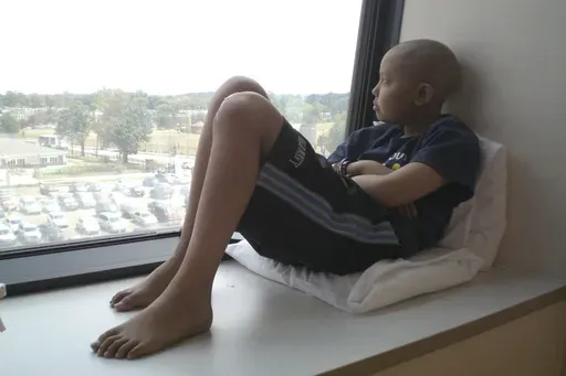 This photo provided by Jeng Hsu shows her son, Jaiwen Hsu, at the Children's National Hospital in Washington in August 2011, weeks before his last round of chemotherapy for bone cancer. (Jeng Hsu via AP)