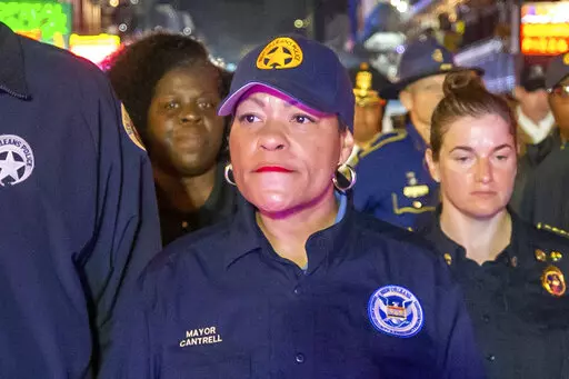 New Orleans Mayor LaToya Cantrell, center, along with other members of law enforcement, NOFD and EMS, walks down Bourbon Street just after midnight ceremoniously closing down Mardi Gras, Wednesday, Feb. 22, 2023, in New Orleans. Opponents of New Orleans Mayor LaToya Cantrell rushed 10 boxes of petitions into City Hall on Wednesday and declared they have enough enough signatures to force a recall of the second-term mayor. (David Grunfeld/The Times-Picayune/The New Orleans Advocate via AP)