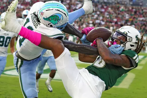 Tulane defensive back Jarius Monroe (11) breaks up a pass intended for South Florida wide receiver Xavier Weaver (10) during the second half of an NCAA college football game Saturday, Oct. 15, 2022, in Tampa, Fla. (AP Photo/Chris O'Meara)