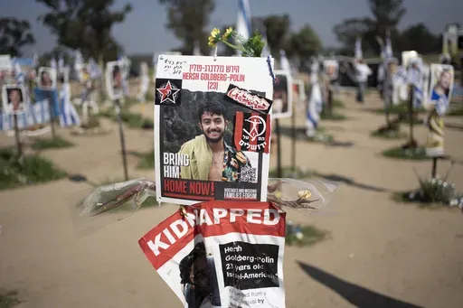 A poster depicting Israeli-American hostage Hersh Goldberg-Polin is displayed in Re'im, southern Israel at the Gaza border, Feb. 26, 2024, at a memorial site for the Nova music festival site where he was kidnapped to Gaza by Hamas on Oct. 7, 2023. Hamas on Wednesday, April 24, 2023, released a recorded video of an Israeli American still being held by the group. The video was the first sign of life of Hersh Goldberg-Polin since Hamas’ Oct. 7 attack on southern Israel. It was not clear when the 