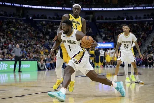 New Orleans Pelicans forward Zion Williamson (1) dribbles around Indiana Pacers forward Pascal Siakam (43) during the second half of an NBA basketball game in New Orleans, Friday, Nov. 1, 2024. (AP Photo/Matthew Hinton)