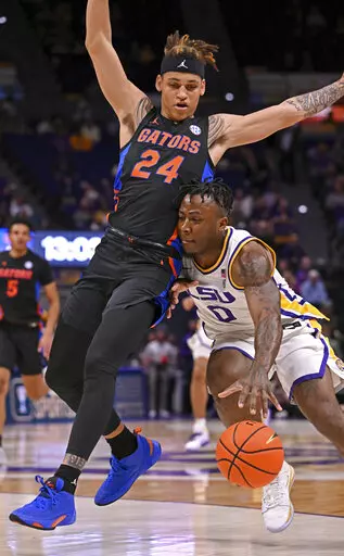 LSU guard Trae Hannibal (0) works to move past Florida guard Riley Kugel (24) during the first half of an NCAA college basketball game Tuesday, Jan. 10, 2023, in Baton Rouge, La. (Hilary Scheinuk/The Advocate via AP)