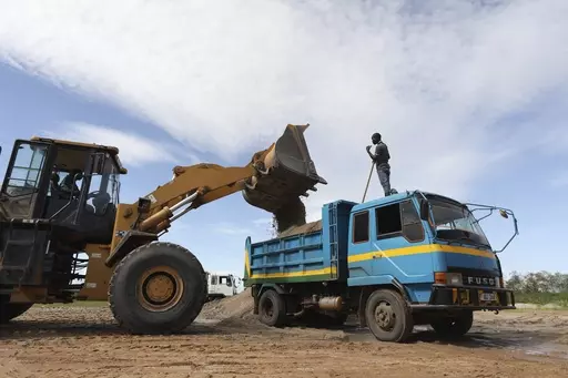 Sand is loaded into a truck at Seroma Ltd. sand mine on April 5, 2023, in the Lwera wetlands near Lukaya, Uganda. The wetland has long been worked over by sand miners, both legal and illegal. Now, all known corporate operations within the wetland have authorization to be there, giving them a measure of legitimacy that's frustrating environmental activists. (AP Photo)