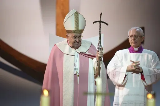 Pope Francis stands as he celebrates a mass Sunday, Dec. 15, 2024 in Ajaccio on the first papal visit ever to the French island of Corsica . (AP Photo/Thibault Camus)