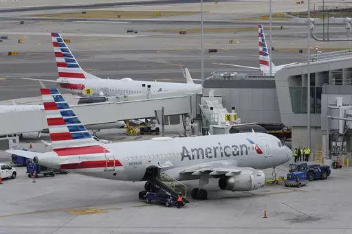 American Airlines planes sit on the tarmac at Terminal B at LaGuardia Airport, Jan. 11, 2023, in New York. American Airlines is raising bag fees and pushing customers to buy tickets directly from the airline if they want to earn frequent-flyer points. American said Tuesday, Feb. 20, 2024, that checking a bag on domestic flights will rise from $30 now to $35 online, and it'll be $40 if purchased at the airport. (AP Photo/Seth Wenig, File)