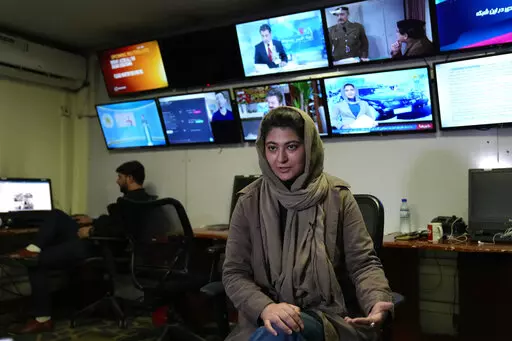 Afghan journalist Banafsha Binesh speaks during an interview with the Associated Press, at TOLO TV newsroom in Kabul, Afghanistan, Tuesday, Feb. 8, 2022. Binesh fear haunts every step when she leaves her home each morning for the newsroom at Afghanistan's largest television station in the Afghan capital Kabul. A December survey jointly carried out by Reporters Without Borders and the Afghan Independent Journalist Association, reported "a total of 231 media outlets have had to close and more than