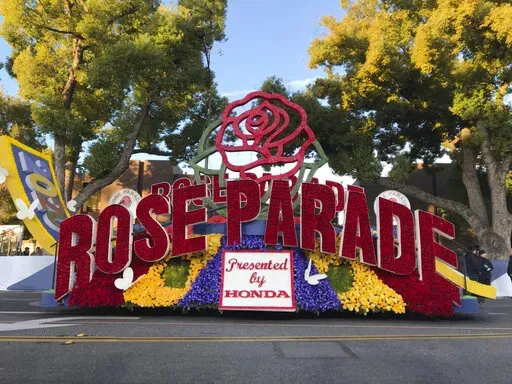 FILE - In this Jan. 1, 2020, file photo, a 2020 Rose Parade float is seen at the start of the route at the 131st Rose Parade in Pasadena, Calif. The Rose Parade and Rose Bowl college football game between Ohio State and Utah were set to go forward on New Year's Day despite surging cases of COVID-19, which forced the cancelation of the 2021 parade. (AP Photo/Michael Owen Baker, File)