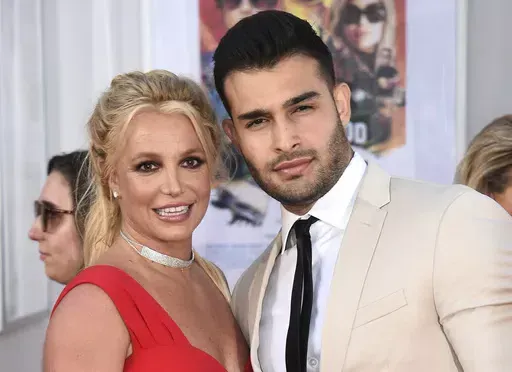 Britney Spears and Sam Asghari appear at the Los Angeles premiere of "Once Upon a Time in Hollywood" on July 22, 2019. Spears has reached a divorce settlement with her soon-to-be-ex-husband Asghari. (Photo by Jordan Strauss/Invision/AP, File)