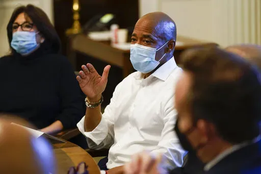 New York City Mayor Eric Adams, center, speaks during a cabinet meeting on his first day in office in New York, Saturday, Jan. 1, 2022. (AP Photo/Seth Wenig)