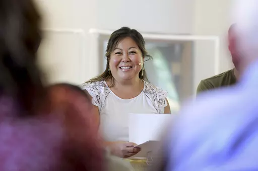 Pastor Juliet Liu of Life on the Vine church speaks during a congregational meeting in Long Grove, Ill., on Sunday, May 22, 2022. The strain of having discussions about race and racism led to burnout for Liu, who co-leads Life on the Vine church, a Christian congregation. She is getting ready to start a six-month sabbatical in July. Liu says she is not sure if she will return to ministry. (AP Photo/Mark Black)