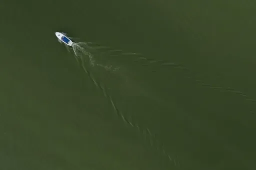 A boat motors through Lake Erie during an algal bloom, Monday, Aug. 26, 2024, at Maumee Bay State Park in Oregon, Ohio. (AP Photo/Joshua A. Bickel)