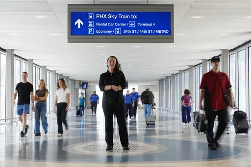Lindsay Ruck, a server at Phoenix Sky Harbor International Airport restaurants, pauses in Terminal 3 as she is anticipates the vote on Arizona Prop 138 on minimum wage Thursday, Oct. 3, 2024, in Phoenix. (AP Photo/Ross D. Franklin)