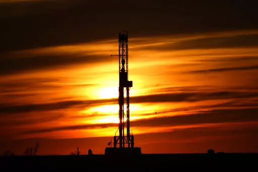 An oil drilling rig is pictured at sunset, Monday, March 7, 2022, in El Reno, Okla. A federal appeals court in New Orleans hears arguments Tuesday, May 10, 2022, about whether President Joe Biden legally suspended new oil and gas lease sales because of climate change worries. (AP Photo/Sue Ogrocki, File)