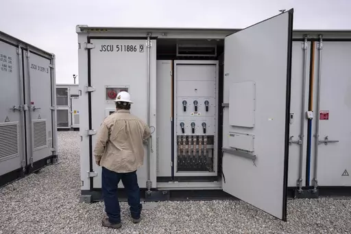 An employee works at a battery energy storage facility in Saginaw, Texas, April 25, 2023, that is owned and operated by Eolian L.P. The U.S. Department of Energy on Friday, Sept. 22, announced a $325 million investment in long-duration battery storage projects. (AP Photo/Sam Hodde, File)