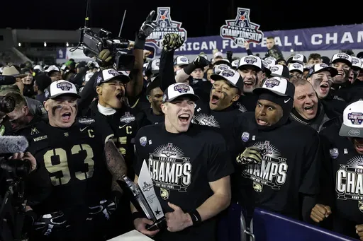Army quarterback Bryson Daily, second left, celebrates with teammates after the American Athletic Conference championship NCAA college football game against Tulane Friday, Dec. 6, 2024, in West Point, N.Y. Army won 35-14. (AP Photo/Adam Hunger)