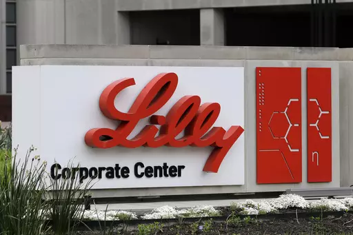 A sign for Eli Lilly & Co. sits outside their corporate headquarters in Indianapolis on April 26, 2017. New research shows another experimental Alzheimer's drug can modestly slow patients' inevitable worsening. Patients given monthly infusions of Eli Lilly and Co.'s donanemab declined about four to seven months more slowly than those given dummy infusions in a large study. (AP Photo/Darron Cummings, File)