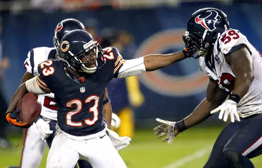 FILE -Chicago Bears' Devin Hester (23) stiff-arms Houston Texans' Whitney Mercilus (59) during a punt return during the second half of an NFL football game, Sunday, Nov. 11, 2012, in Chicago. Devin Hester is a finalist for the Pro Football Hall of Fame's class of 2022.(AP Photo/Charles Rex Arbogast, File)