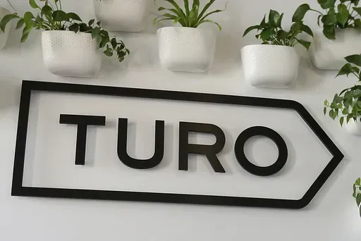 The Turo logo is shown in the entryway of Turo in San Francisco, April 29, 2019. (AP Photo/Eric Risberg, File)