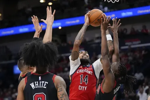 New Orleans Pelicans forward Brandon Ingram (14) goes to the basket against Chicago Bulls guard Ayo Dosunmu in the first half of an NBA basketball game in New Orleans, Wednesday, Oct. 23, 2024. (AP Photo/Gerald Herbert)