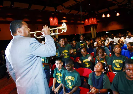 Jazz trumpeter Wynton Marsalis performs for school children during a program "Cookin' with Jazz'' with celebrity chef Emeril Lagasse in New Orleans, Aug. 28, 2006. During Carnival season, flocks of marching bands parade through the city streets even though jazz music and dancing has been banned in New Orleans public schools for almost a century. The Times-Picayune/The New Orleans Advocate reports the Orleans Parish School Board is poised this week to reverse that policy 100 years after it was pa