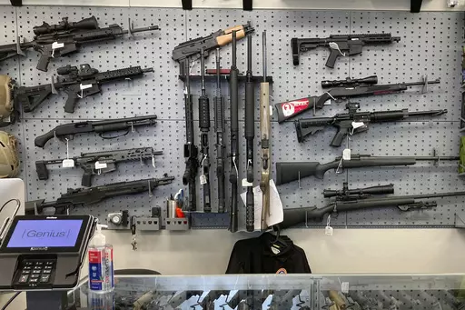 Firearms are displayed at a gun shop in Salem, Ore., Feb. 19, 2021. A federal judge in Portland, Ore., will hear arguments Monday, June 5, 2023, over the constitutionality of one of the nation's strictest gun control laws that was approved by voters last year. The law, which includes a permit-to-purchase provision for gun owners, has been challenged in both federal court and state court and the legal battle over Measure 114 is likely to continue no matter the outcome this week. (AP Photo/Andrew 