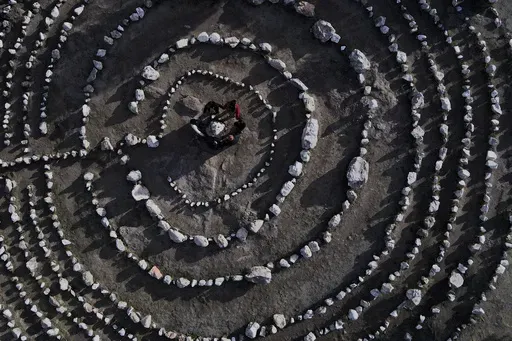 A group of Brazilian tourists hold hands standing in a circle at the heart of a stone labyrinth in the Pueblo Encanto spiritual theme park in Capilla del Monte, Argentina, Wednesday, July 19, 2023. In the pope’s homeland of Argentina, Catholics have been renouncing the faith and joining the growing ranks of the religiously unaffiliated. Commonly known as the “nones,” they describe themselves as atheists, agnostics, spiritual but not religious, or simply: “nothing in particular.” (AP Ph