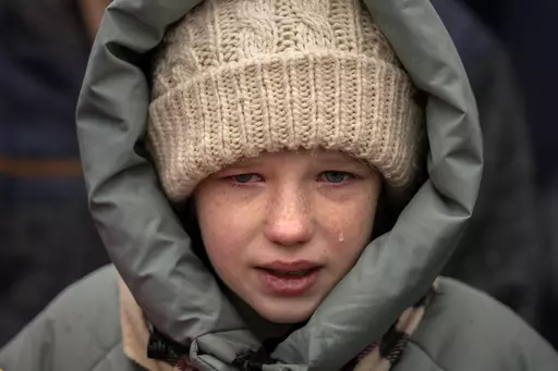 Anna, 10, cries next to the body of her brother Yurii, 27, during his funeral in Kalynivka, near Kyiv, Ukraine, Tuesday, Feb. 21, 2023. Yurii Kulyk, a civilian who was a volunteer in the armed forces of Ukraine, was killed during a rocket attack on Feb.15 in Lyman, a city in the Donetsk region of Ukraine. (AP Photo/Emilio Morenatti)