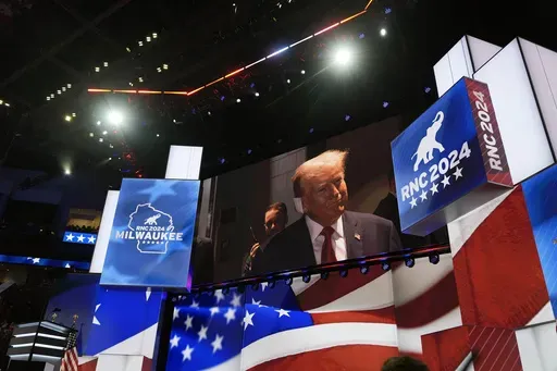 Republican presidential candidate former President Donald Trump is seen on a video monitor as he arrives to attend the first day of the Republican National Convention, Monday, July 15, 2024, in Milwaukee. (AP Photo/Carolyn Kaster)