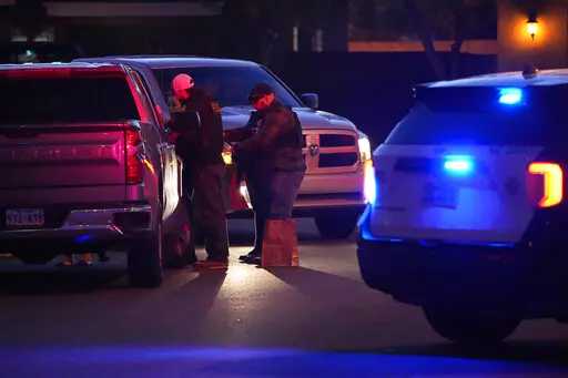 Las Vegas police work near the home of former actor Nathan Lee Chasing His Horse, who goes by Nathan Chasing Horse, Tuesday, Jan. 31, 2023, in North Las Vegas, Nev. Authorities raided the home of the former actor Tuesday in connection with a sexual assault investigation. (AP Photo/John Locher)