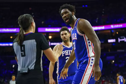 Philadelphia 76ers' Joel Embiid, right, argues the foul called against him by referee Natalie Sago, left, during the first half of an NBA basketball game against the New Orleans Pelicans, Monday, Jan. 2, 2023, in Philadelphia. (AP Photo/Chris Szagola)