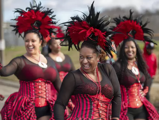 Member of the Mystic Krewe of Femme Fatale have fun with the crowd as the Krewe of Nefertiti rolls along Lake Forest Blvd. in New Orleans East , Sunday, Jan. 28, 2024. (David Grunfeld/The Times-Picayune/The New Orleans Advocate via AP)