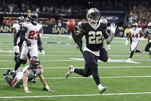 New Orleans Saints' Rashid Shaheed (22) gestures while returning a punt for a touchdown past Tampa Bay Buccaneers punter Jake Camarda (5) during the first half of an NFL football game in New Orleans, Sunday, Oct. 13, 2024. (AP Photo/Butch Dill)