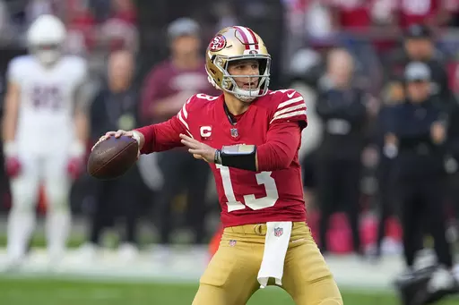 San Francisco 49ers quarterback Brock Purdy passes against the Arizona Cardinals during the first half of an NFL football game Sunday, Dec. 17, 2023, in Glendale, Ariz. (AP Photo/Matt York)