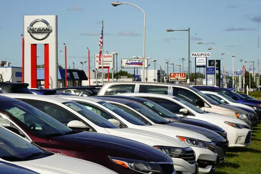 Cars for sale line the road at a used auto dealership in Philadelphia, Thursday, Sept. 29, 2022. The prices of new and used vehicles in the United States have begun inching down from their eye-watering record highs as more vehicles have become gradually available at dealerships. (AP Photo/Matt Rourke, FILE)
