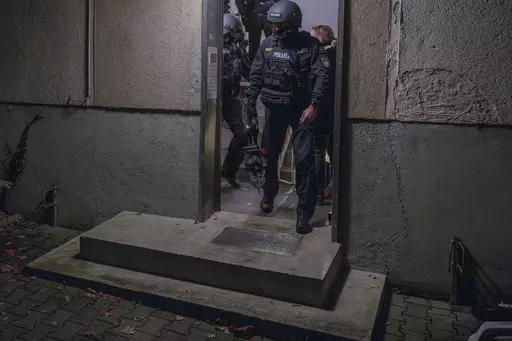 Police officers leave a house during a raid in the early hours of the morning in Munich, Germany, on Nov. 21, 2023. German authorities have raided the premises of 17 people in Bavaria accused of spreading antisemitic hate speech and threats to Jews online. (Peter Kneffel/dpa via AP, File)