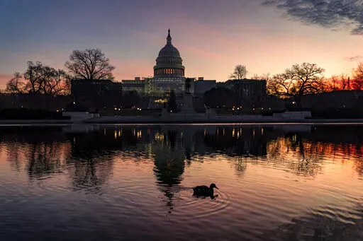 The Capitol is seen in Washington, early Wednesday, Dec. 14, 2022. Lawmakers leading the negotiations on a bill to fund the federal government for the current fiscal year say they've reached agreement on a "framework" that should allow them to complete work on the bill over the next week and avoid a government shutdown. (AP Photo/J. Scott Applewhite)