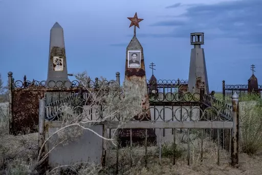 Graves are visible near the dried-up Aral Sea outside Aralsk, Kazakhstan, Monday, July 3, 2023. (AP Photo/Ebrahim Noroozi)