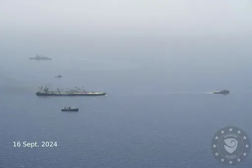 In this photo released of EUNAVFOR ASPIDES, the EU naval mission working in the Red Sea, on the X-platform formerly known as Twitter, on Sept. 16, 2024, the Greek-flagged oil tanker MV-Sounion, left, is towed. Salvagers successfully towed a Greek-flagged oil tanker ablaze for weeks after attacks by Yemen's Houthi rebels to a safe area without any oil spill, a European Union naval mission said Monday. (EUNAFOR ASPIDES via AP)