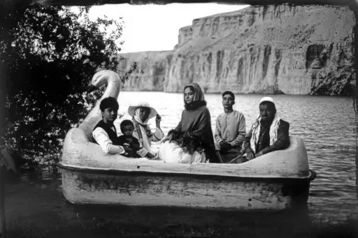 The Moradi family sits for a portrait on a small boat in Band-i-Mir lake, one of the tourist attractions in the Bamiyan Valley region in Afghanistan, Saturday, June 17, 2023. The family traveled a long way from Helmand to spend a few days for their summer vacation. During their first stint in power from 1996 to 2001, the Taliban banned photography of humans and animals as contrary to the teachings of Islam. Many box cameras were smashed, though some were quietly tolerated, Afghan photographers s