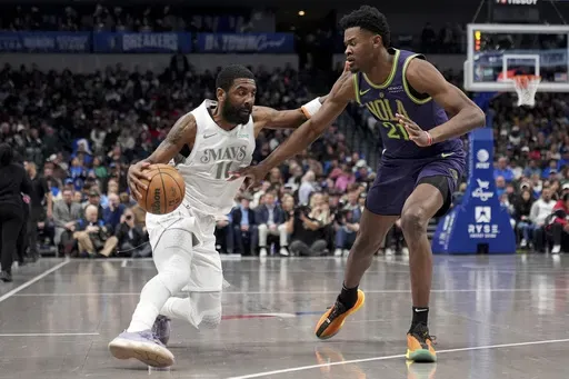 Dallas Mavericks guard Kyrie Irving, left, works against New Orleans Pelicans center Yves Missi (21) in the first half of an NBA basketball game in Dallas, Friday, Feb. 21, 2025. (AP Photo/Tony Gutierrez)