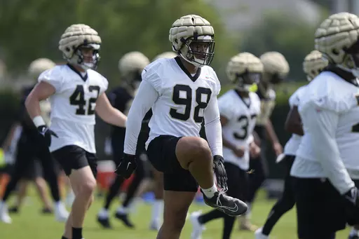 New Orleans Saints defensive end Payton Turner (98) runs through drills during the NFL football team's practice in Metairie, La., May 30, 2023. Turner is a 2021 first-round draft pick out of Houston whose on-field development has been stunted by shoulder and ankle injuries during his first two NFL seasons. Now he’s looking to fill a void in the starting lineup left by Marcus Davenport’s departure from the club in free agency. (AP Photo/Gerald Herbert, File)