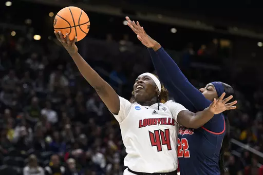 Louisville forward Olivia Cochran (44) scores a layup as Mississippi forward Tyia Singleton (22) defends during the first half of a Sweet 16 college basketball game in the women's NCAA Tournament in Seattle, Friday, March 24, 2023. Despite this summer’s successful performance, Louisville coach Jeff Walz cautions that cohesion is a work in progress as the new faces blend with seniors Olivia Cochran (8.4 points, 6.5 rebounds per game) and Merissah Russell and sophomores Nyla Harris and Alexia Mo