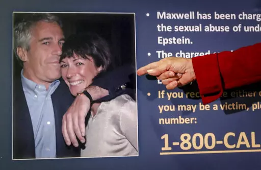 Audrey Strauss, acting U.S. attorney for the Southern District of New York, points to a photo of Jeffrey Epstein and Ghislaine Maxwell, during a news conference in New York on July 2, 2020. A judge has declined to throw out Maxwell’s sex trafficking conviction, despite a juror’s failure to disclose he’d been a victim of childhood sexual abuse. U.S. District Judge Alison J. Nathan on Friday, April 1, 2022, refused to order a new trial for Maxwell, who was convicted in December of helping th