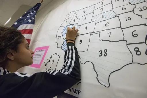 Mia Lemon, 13, an eighth grader at Skyline Middle School, marks Nevada as a blue state as she counts ballots cast by her fellow students during the school's mock presidential election Wednesday, Nov. 2, 2016, in Harrisonburg, Va. (Nikki Fox/Daily News-Record via AP, File)