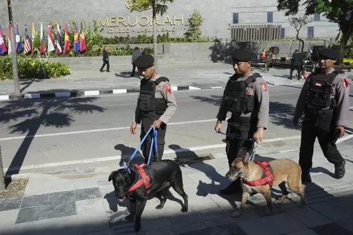 Indonesian police K9 patrol in front of Meruorah hotel in Labuan Bajo, East Nusa Tenggara province, Indonesia, Monday, May 8, 2023. Indonesian President Joko Widodo will host fellow leaders of the Association of Southeast Asian Nations this week in their annual summit in Labuan Bajo. (AP Photo/Achmad Ibrahim)