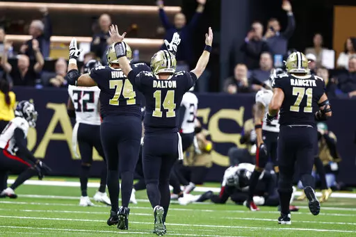New Orleans Saints quarterback Andy Dalton (14) reacts after a touchdown by tight end Juwan Johnson (83) In the first half of an NFL football game against the Atlanta Falcons in New Orleans, Sunday, Dec. 18, 2022. (AP Photo/Butch Dill)